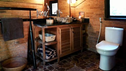 a bathroom with a sink and a toilet at HIDDEN HEAVEN Rumah Barong in Jasri