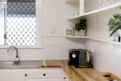 a kitchen with a counter top with a toaster on it at Murwillumbah Motor Inn in Murwillumbah