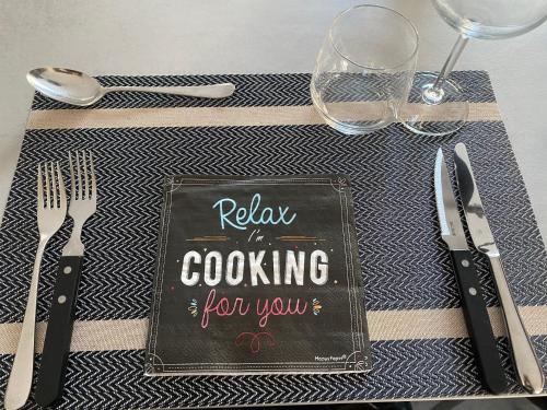 a table with a sign that says relax in cooking for you at le 701 in Theux