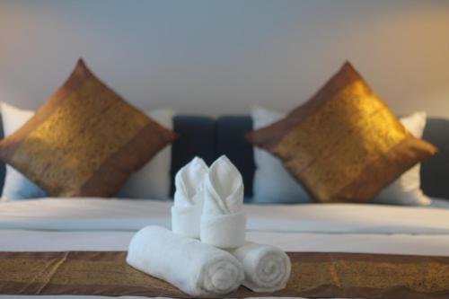 a hotel room with towels on a bed at Benny's City Hotel in Sihanoukville