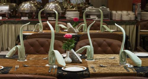 a table with plates and utensils on top at Hotel Viceroy in Darjeeling