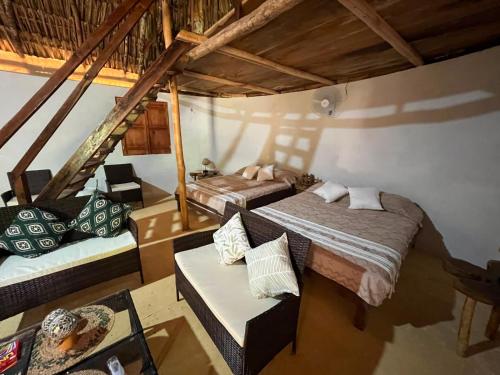 a room with two beds and a couch in it at Eco Hacienda ICH-KI in Hoctún