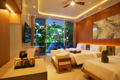 a hotel room with two beds and a table at Lighthouse Hotel in Gili Trawangan