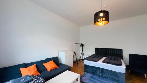 a living room with a couch and a bed at Junior Suite Apartment Eleven in Graz