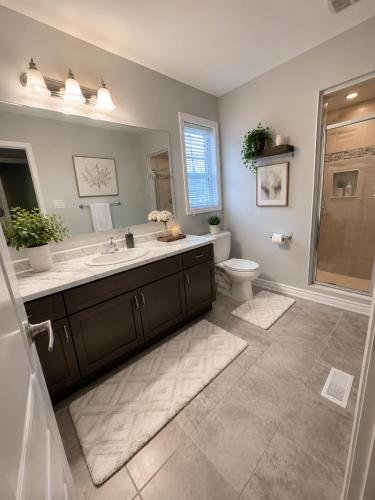 a bathroom with a sink and a toilet and a shower at Gifted Beautiful Home in Brampton