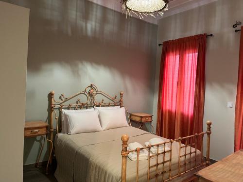 a bedroom with a bed and a red curtain at Secret-Garden in Chios