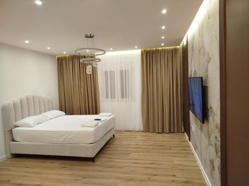 a bedroom with a large white bed and curtains at Boci studio apartments in Ulcinj