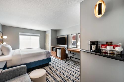 a hotel room with a bed and a desk at AmericInn by Wyndham Fairfield in Fairfield