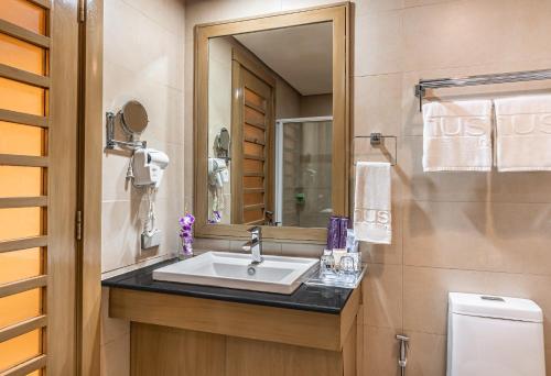 a bathroom with a sink and a mirror at The Muse Hotel Boracay in Boracay