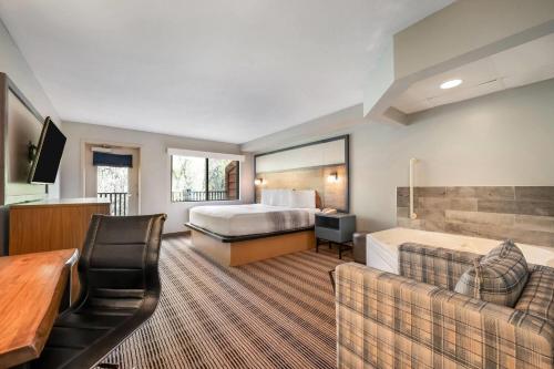 a hotel room with a bed and a couch at AmericInn by Wyndham Wisconsin Dells in Wisconsin Dells