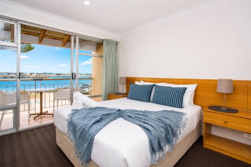 a bedroom with a bed and a balcony at Mariners Lookout Absolute Harbour Views in Fremantle