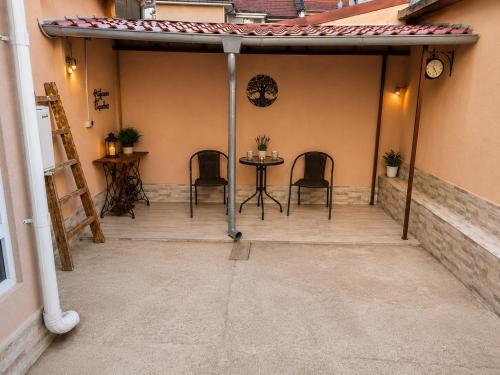 a patio with chairs and a table in a building at Apartment The Garden Ruse, Private Garden & Free Parking in Ruse