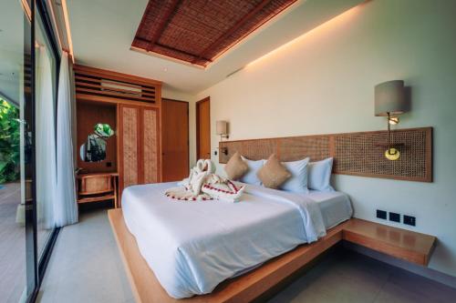 a bedroom with a large bed in a room at Candidasa Hills in Candidasa
