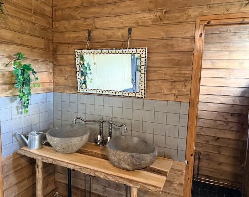 two sinks on a wooden counter in a bathroom at Kangasjoki Riverside Camp in Suomussalmi