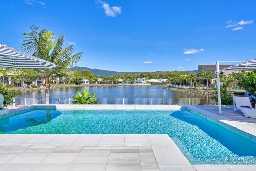 a swimming pool with a view of a river at Villa Aura - Private Pool - Lakefront & Near Beach in Trinity Beach
