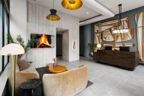 a living room with a couch and a fireplace at The Heid Lofts by Reside, a Wyndham Residence in Philadelphia