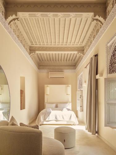a bedroom with a white bed and a ceiling at Riad Djannaat Exceptional private riad pool staff in Marrakesh