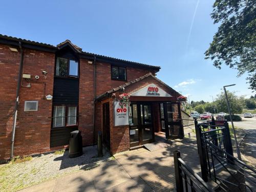 a brick building with a sign in front of it at OYO Lakeside Haydock Hotel, St Helens, A580 East Lancs, Garswood Old Road in Saint Helens