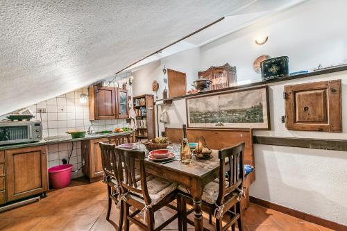 a kitchen with a wooden table and chairs at Champlas Suite - Happy Rentals in Sestriere