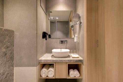 a bathroom with a sink and a mirror at Keys Lite by Lemon Tree Hotels, Ajmer in Ajmer