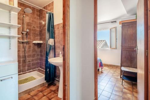a bathroom with a shower and a sink at Maison Vacances Mer in Bages