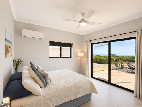 a bedroom with a bed and a window with a view at Explorers Roost in Kalbarri