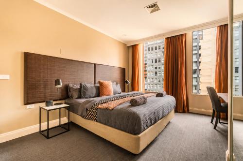 a bedroom with a large bed and a large window at Stylish CBD 1BR - Gym & Lounge - Next to Chinatown in Melbourne