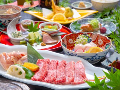 a table with many plates of food on it at Yufuin Yasuha in Yufu