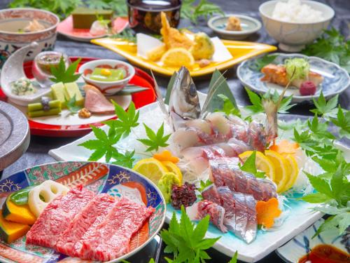 a table with many plates of food on it at Yufuin Yasuha in Yufu