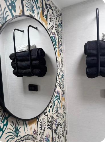 a mirror on a wall with towels in a bathroom at Cozy RV tiny home in Fort Lauderdale