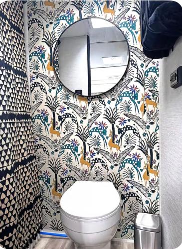 a bathroom with a toilet and a mirror at Cozy RV tiny home in Fort Lauderdale