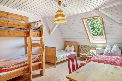 a bedroom with two bunk beds and a table at Das Falken Nest in Eisenbach