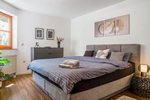 a bedroom with a bed with a blue blanket at Fewo Stembers in Heideck