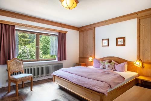 a bedroom with a large bed and a window at Ferienhaus Isele in Feldberg