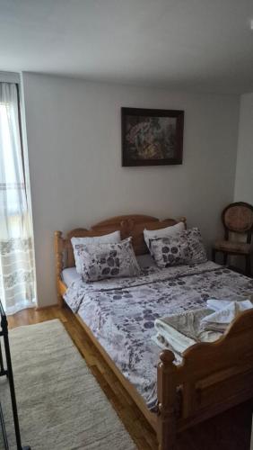a bedroom with a large bed with pillows on it at DSM & Victory in Plužine