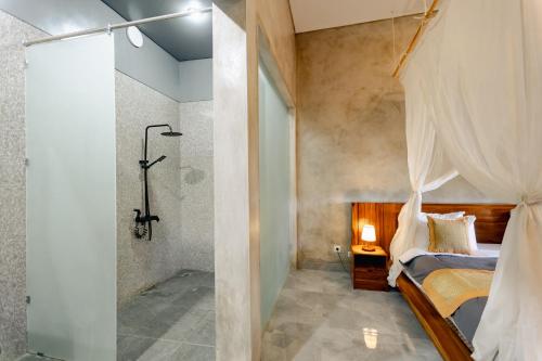 a bedroom with a shower and a bed in a room at Rana Suite in Ubud