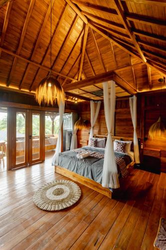 a bedroom with a bed in a room at Rana Suite in Ubud