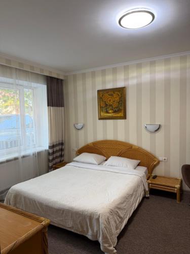 a bedroom with a large bed with white sheets at For You in Odesa