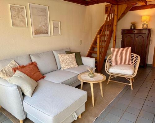 a living room with a couch and a chair at Dat Lüttje in Fehmarn
