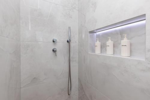 a bathroom with a shower with two soap bottles at Villa Andrionas Private Pool & Total Privacy in Corfu