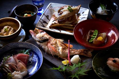 a table with plates of food and bowls of food at Kocho in Kaga