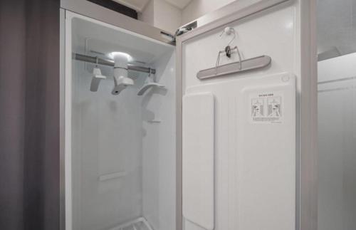 a shower with a glass door in a bathroom at Ehan Hotel in Mokpo