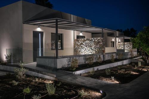 a house with a lit up facade at night at Avli Residences in Kos