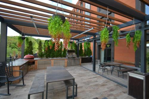 an outdoor patio with tables and chairs and plants at Domel Tsaghkadzor in Tsaghkadzor