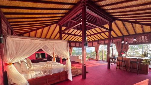 a bedroom with a canopy bed in a house at The Joglo Sekar Munduk in Pabean Buleleng