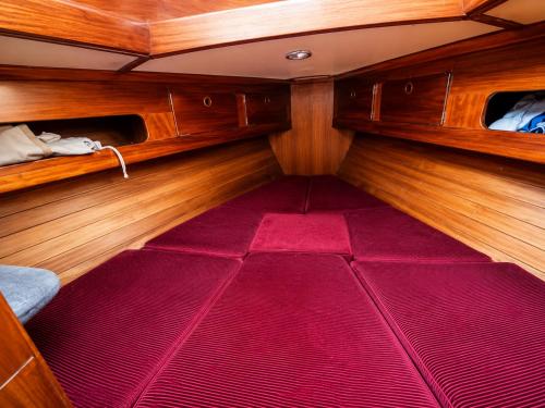 a small room with a red floor in a boat at Garuda yacht in Nida