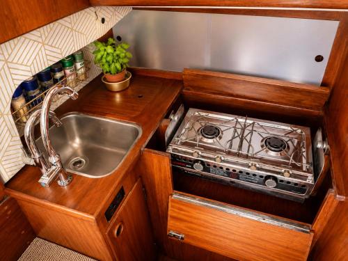 a kitchen with a sink and a stove at Garuda yacht in Nida