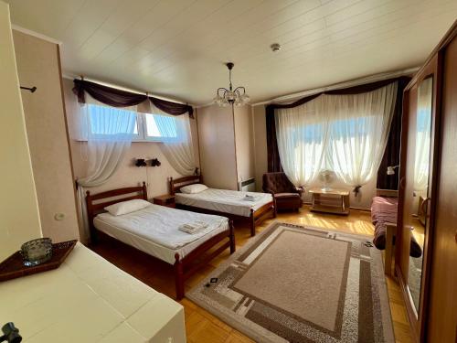 a living room with two beds and a couch at Seedri Guesthouse in Pärnu