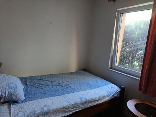 a bedroom with a bed and a window with the eiffel tower at RoomForRent in Konjic
