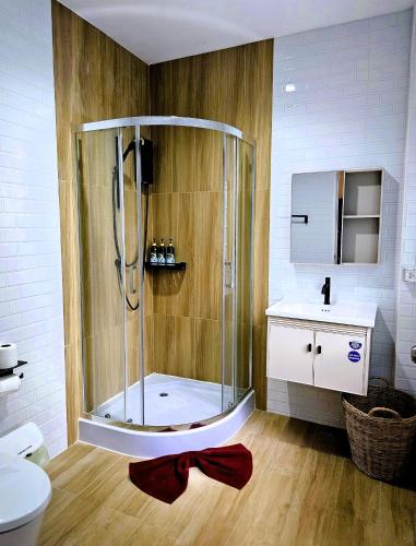 a bathroom with a shower with a red bow on the floor at Suwaree Garden in Koh Samui